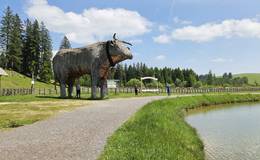 Teichalmsee lake with wooden ox on the Teichalm in the Almenland Nature Park