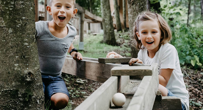 Children on the wooden ball track