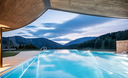 Panoramic pool at night at the Almwellness Hotel Pierer