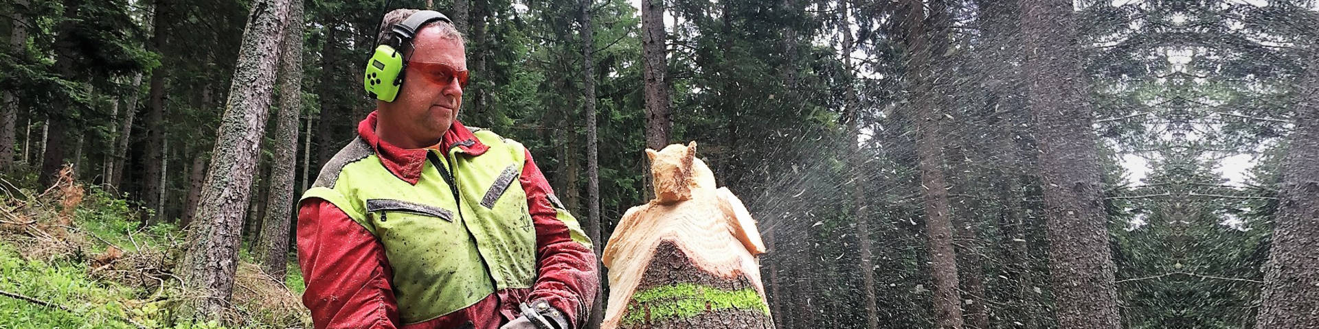 Chainsaw carver Erich Haider Harrer with his sculptures